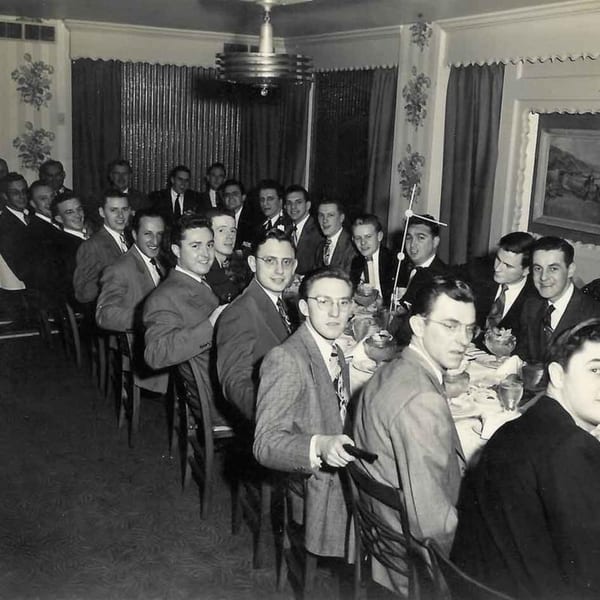 A black and white photo of many men in suits seated at a long table in Marrelli's Italian Restaurant.