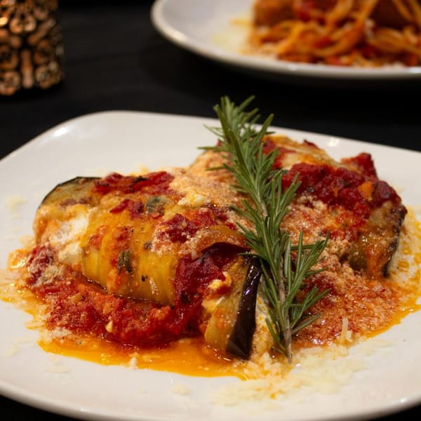 Marrelli's Italian Restaurant's eggplant parmesan, topped with tomato sauce, cheese, and a rosemary sprig.