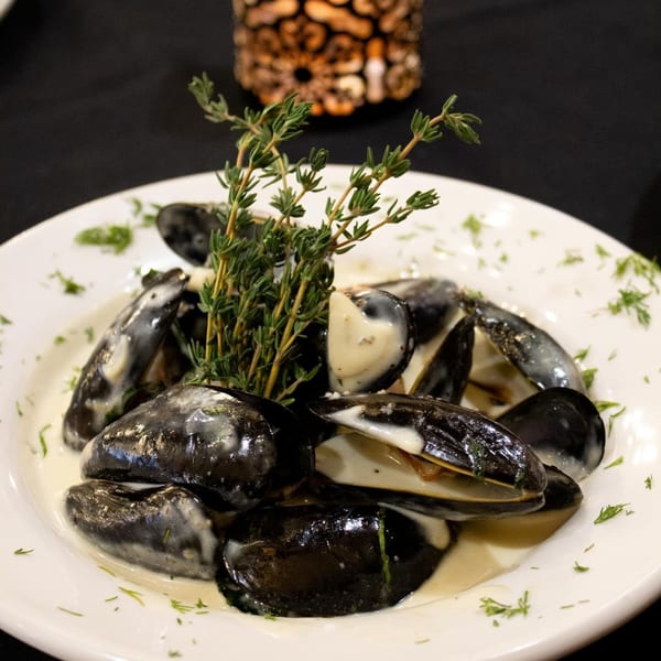 Marrelli's Italian Restaurant's mussels in a creamy sauce, garnished with fresh thyme and dill.