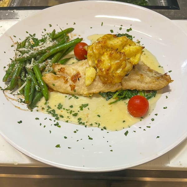 Marrelli's Italian Restaurant's fish entree with green beans, cherry tomatoes, and a creamy sauce.